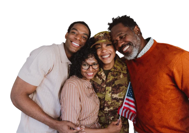 A family embracing a loved one in uniform
